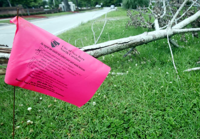 The city of New Bern is red flagging debris they are unable to remove from property. The flag pictured above, notes that the debris is too long for removal from this National Avenue property, since it is more than 5 feet long.