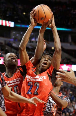 Kansas signee Andrew Wiggins (22), shown here battling Kentucky signee Julius Randle in the McDonald's All-America Game, created a considerable buzz in his first pickup game in Lawrence.
