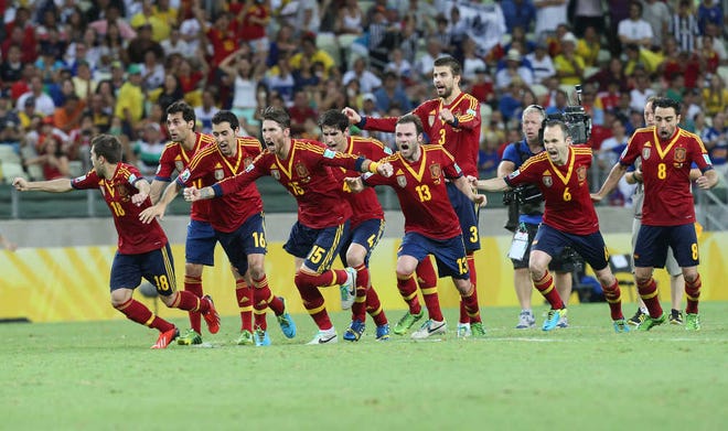 Spain players celebrate their semifinal win over Italy. The reigning world champions will take on Confederations Cup host Brazil in Sunday's final.
