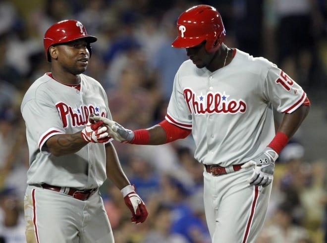 The Phillies' Delmon Young, left, congratulates teammate John Mayberry Jr. after Mayberry hit a two-run home run against the Dodgers in the sixth inning Friday in Los Angeles.