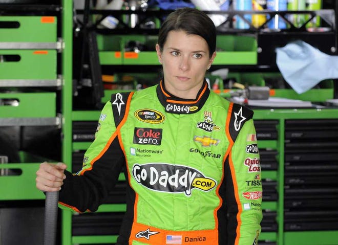 Danica Patrick looks on as crew members work on her car during practice for Sunday's NASCAR Sprint Cup series Coca-Cola 600 auto race at Charlotte Motor Speedway in Concord, N.C., Thursday, May 23, 2013. (AP Photo/Mike McCarn)