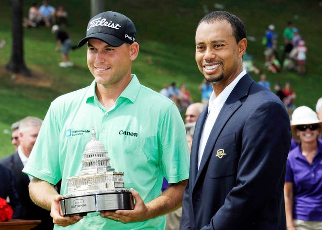 Bill Haas, left, poses with Tiger Woods after winning the AT&T National golf tournament at Congressional Country Club, Sunday, June 30, 2013, in Bethesda, Md. (AP Photo/Nick Wass)