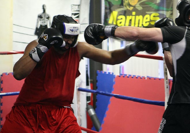 Boxer Julian Pollard, left, spars with Mark Griffin at Bishop’s Training and Fitness  in West Bridgewater