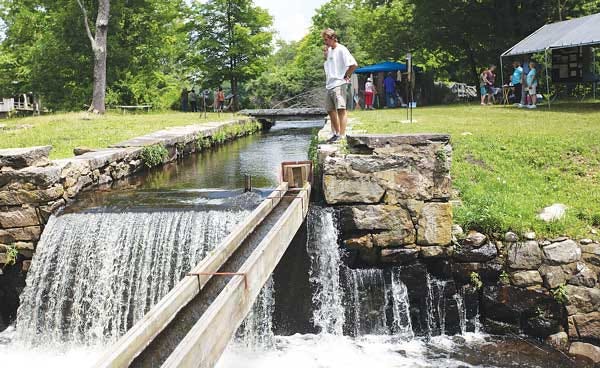 Photo by Amy Herzog/New Jersey Herald - People explore the different exhibits and watch water enter the Morris Canal through a lock during Canal Day at Waterloo Village in Byram.
