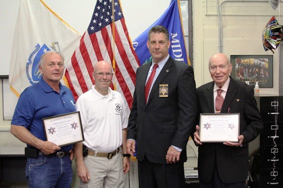 Middlesex Sheriff Peter J. Koutoujian (second from right) and Community Affairs Director Ken Doucette (second from left) congratulate Medford residents William Young (left) and James Houlihan (right) upon their graduation from the Middlesex Sheriff’s Office Citizens Academy.