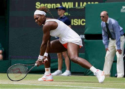 Serena Williams of the United States follows through on a return during her Women's singles match against Sabine Lisicki of Germany at the All England Lawn Tennis Championships in Wimbledon, London, Monday, July 1, 2013.