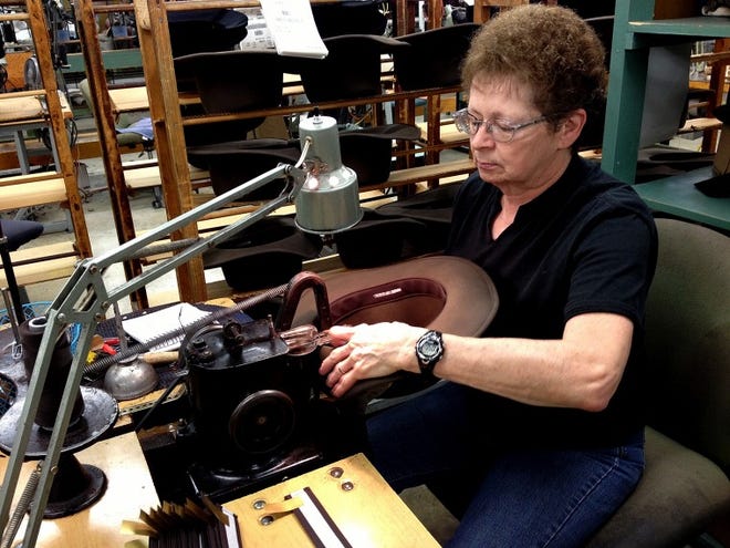 Bollman Hat Co. employee Marian Boyer sews a sweatband inside a hat that the company makes for Beretta. Bollman, the nation's oldest hat manufacturer, is the driving force behind American Made Matters, which strives to educate consumers on why they should buy goods made in the U.S.