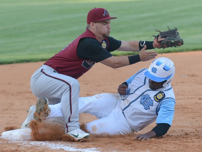 Henderson County's Thomas Waddell slides safely into third base during a game against Asheville earlier this year at East Henderson.