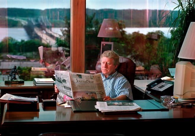 John T. McConnell, former president and publisher of the Journal Star, reads the paper in his office in this 1999 file photo. McConnell died Monday morning at the age of 68.