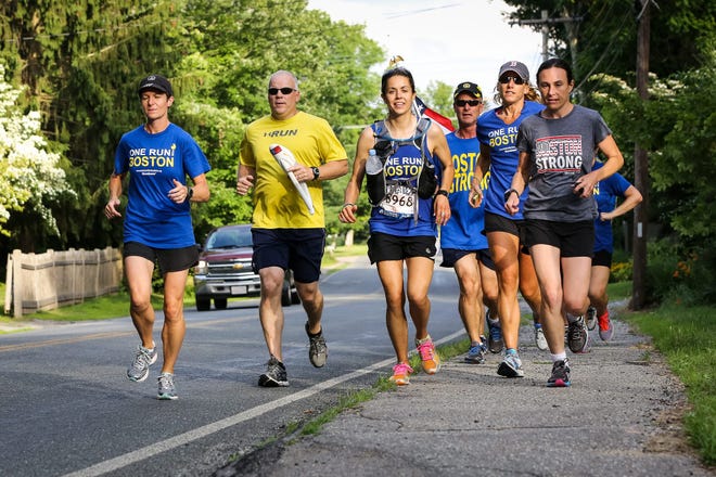 Runners head down North Ave. in Mendon for the 5.5-mile leg to Upton during the One Run for Boston cross-country relay on Sunday. The One Run for Boston relay ran non-stop from Los Angeles to Boston.