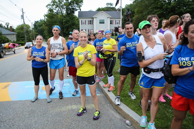 Spectators, runners, and family members cheer runners at the Boston Marathon start line in Hopkinton as they finish their relay leg during the One Run for Boston cross-country relay on Sunday. The One Run for Boston relay ran non-stop from Los Angeles to Boston.