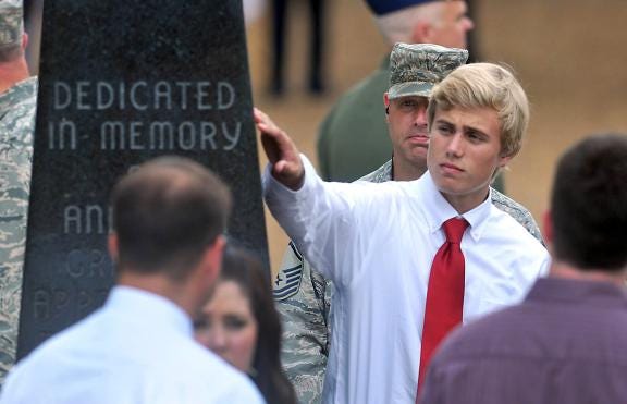 Alex Cannon, 17, touches an inscription of his father, Robert's, name during a July 10, 2012, memorial service for four N.C. Air National Guardsmen killed when their plane crashed while fighting a South Dakota wildfire. Another ceremony in South Dakota honored the men Monday on the one-year anniversary of the crash July 1, 2012. (Associated Press/Todd Sumlin)