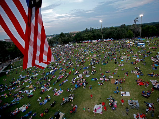 A large American flag flops in the breeze above the Fanfare & Fireworks celebration at Flavet Field on July 3, 2012.