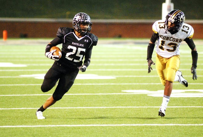 Havelock’s Taylor Woods runs past Concord’s Keenan Black during the state 3A championship game last year at Winston-Salem. Woods is beginning to receive college scholarship offers entering his senior season.