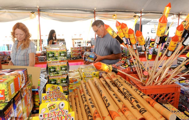 Steve and Nan Geibel of Columbia look over fireworks Monday at Compton’s Fireworks on Range Line Street at East Boone Industrial Drive north of town. This year for the first time, possession of fireworks inside the city limits is against the law.