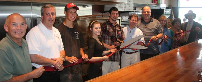 Clemento’s Pizzeria and Brew, located in Rochester Crossing off Washington Street, recently had a Rochester Chamber of Commerce ribbon cutting. From left are Brad Jett from MetroCast, Asst. Fire Chief Mark Dupuis, Alan Clement, Korah Desautel, owner Andrew Clement, Chamber Chairman Bruce Boudreau of Acme Rug and Upholstery, Chamber Chair Elect Mark Farrell of Laars Heating Systems, Mary Ellen Humphrey of the Economic Development Office, Chamber President Laura Ring and Rich Hilow of LPL Financial. For more information on Clemento’s, check out clementopizzeriabrew.webs.com or call 332-5251.