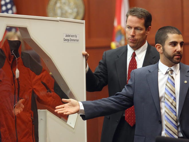 Florida Department of Law Enforcement Crime Lab Analyst Anthony Gorgone, right, points to a jacket worn by George Zimmerman on the night Zimmerman shot Trayvon Martin during Zimmerman's trial in Seminole circuit court, in Sanford, Fla., Wednesday, July 3, 2013. Zimmerman is charged with second-degree murder in the fatal shooting of Trayvon Martin, an unarmed teen, in 2012. Behind Gorgone is Assistant District Attorney John Guy. (AP Photo/Orlando Sentinel, Jacob Langston, Pool)