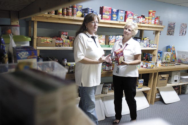 INDEPENDENT KEVIN WHITLOCK
n Jeannie Soley, Program Manager of USO of Northern Ohio , left, and Melissa Seibert, American Red Cross Regional Manager, talk about the assistance room of the USO with non perishable foods and toiletries to provide to military personnel families.
