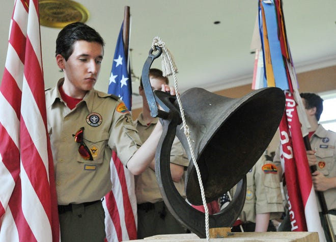 Boy Scout Troop 22 member Alexander Kephart rings a bell in memory of deceased members of the Braintree Bi-Centennial Time Capsule Society. The ceremony was held on Thursday, July 4, 2013.