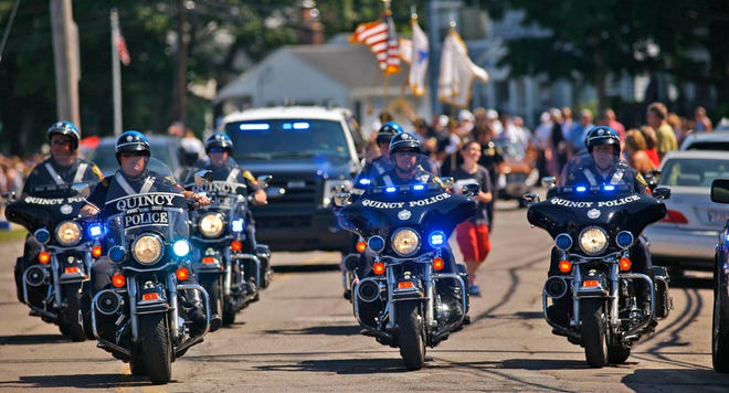 Motorcycle officers from the Quincy Police Department ride in formation in Squantum’s Fourth of July parade on Thursday, July 4, 2013.