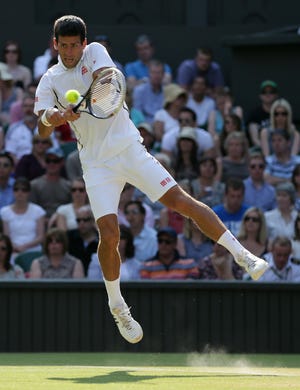 Novak Djokovic of Serbia returns to Juan Martin Del Potro of Argentina during their Men's singles semifinal match at the All England Lawn Tennis Championships in Wimbledon, London, Friday, July 5, 2013. ()