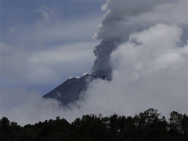 A plume of ash and steam rises from the Popocatepetl volcano during a brief view from cloud cover as seen from the town of Santiago Xalizintla, Mexico, Saturday, July 6, 2013. Just east of Mexico City, the volcano has spit out a cloud of ash and vapor 2 miles high over several days of eruptions. Mexico's National Center for Disaster Prevention raised the volcano alert from Stage 2 Yellow to Stage 3 Yellow, the final step before a Red alert, when possible evacuations could be ordered.