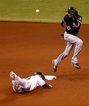 Tampa Bay Rays' Desmond Jennings slides in safely with a steal of second base as Chicago White Sox shortstop Alexei Ramirez jumps for a high throw during the fourth inning of a baseball game Friday, July 5, 2013, in St. Petersburg, Fla. (AP Photo/Mike Carlson)