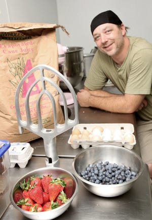 Chris Bernstein photos/ Wicked Local
Ob La Da Bakery Cafe owner/baker Kevin Shain prepares to bake strawberry and blueberry muffins. The photo was taken on Tuesday, June 25, 2013.