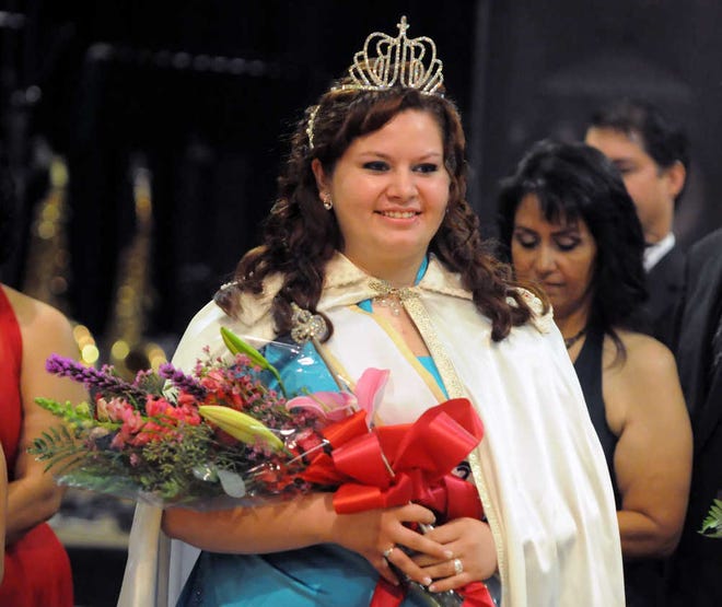 Newly crowned Fiesta Mexicana 2013 Queen Chelsea Garcia Newman, daughter of John Newman and Debra Garcia-Newman, beams after being presented the official trappings of her office. She and five other royalty candidates raised $119,147 for Holy Family School, it was announced Saturday night at the coronation ball in Sunflower Ballroom of the Maner Conference Centre at the Kansas Expocentre.