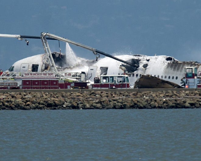 A fire truck sprays water on Asiana Flight 214 after it crashed at San Francisco International Airport on Saturday in San Francisco.