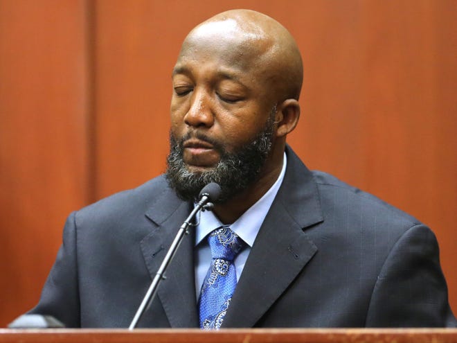 Tracy Martin, father of Trayvon Martin, closes his eyes as he testifies as a defense witness in George Zimmerman's trial in Seminole Circuit Court, in Sanford, Fla., Monday, July 8, 2013. Zimmerman is charged with second-degree murder in the fatal shooting of Trayvon Martin, an unarmed teen, in 2012.