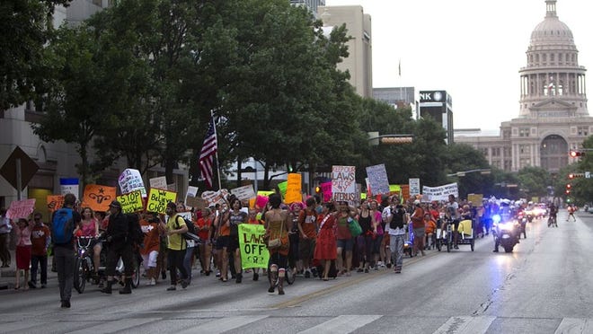 Abortion rights activists march down Congress Avenue Monday evening.