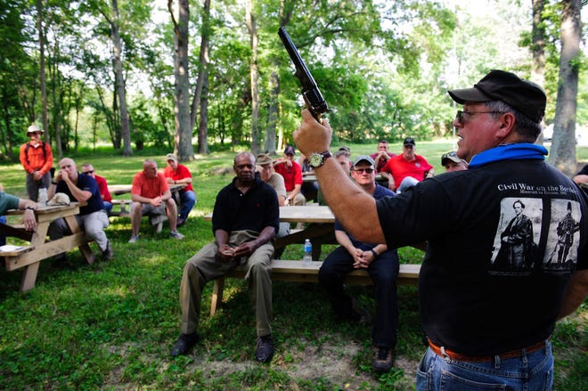 During a tour Monday of the Centralia battlefield, Army historian Dave Chuber shows a .36-caliber Colt Navy revolver, a type of weapon that was used in the Civil War battle. Army leadership from Fort Leonard Wood toured the site yesterday in a study of what happened in the historic battle and what lessons can be drawn from it.