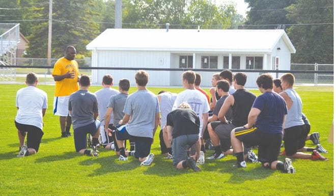 Ira Childress of the Lake Michigan Football Report talks to high school football players during the Report's “Best of the Best” tour football combine at Cheboygan's Western Avenue Field on Tuesday.