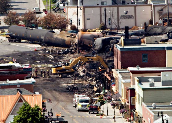 Searchers dig through the rubble Monday for victims in Lac-Megantic, Quebec, after a train derailed, igniting tanker cars carrying crude oil early Saturday.