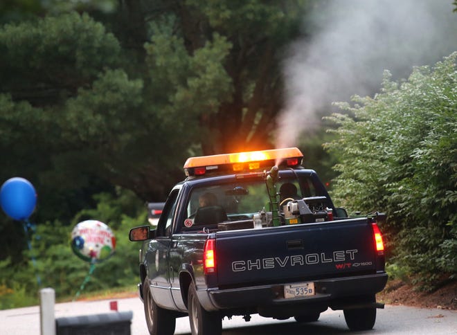 The East Middlesex Mosquito Control Project sprays along a North Sudbury road Monday evening. The project will be spraying in Framingham Tuesday.