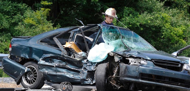After the driver of this car was taken by medical helicopter to a hospital, Marshalls Creek Fire Department Assistant Chief Joe Luisi Jr. looks over the damage. At least two cars collided around 2 p.m. on Route 209 about a half mile north of Marshalls Creek. At least two passengers in the other car, a GMC Acadia, were taken to Pocono Medical Center. State police are investigating the cause of the wreck.