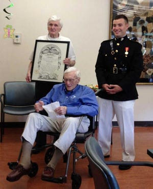 From left: Citadel graduate Vincent Williams, 91, holds the Citadel diploma for his brother, Robert Williams, 93, as recent Citadel graduate 2nd. Lt. Scott Holmes stands by Saturday in Ponte Vedra Beach.