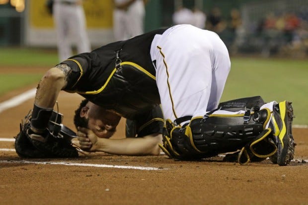 Pittsburgh Pirates catcher Russell Martin reacts after being hit by a foul tip during the first inning of a baseball game against the Oakland Athletics in Pittsburgh Tuesday, July 9, 2013. Martin remained in the game. (AP Photo/Gene J. Puskar)