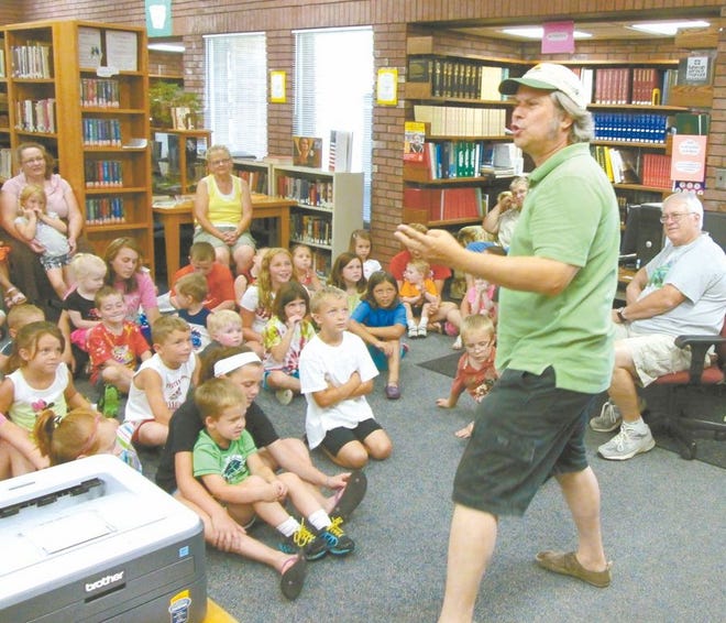 Storyteller Brian “Fox” Ellis takes youngsters and parents in the Spoon River Public Library summer reading program to Africa and beyond with a story about talking yams, dogs and thrones.
