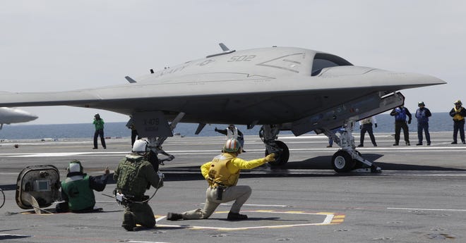 A Navy X-47B drone is launched off the nuclear powered aircraft carrier USS George H. W. Bush off the coast of Virginia, in this May 14, 2013 file photo. The Navy says the X-47B experimental aircraft will try to land aboard the USS George H.W. Bush on Wednesday July 10, 2013. (AP Photo/Steve Helber, File)