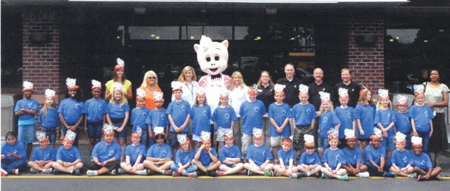 Greg Floyd and Rusty Beaman, both of Piggly Wiggly, led Banks Elementary School students on a tour of the Piggly Wiggly at Green Tree Plaza.