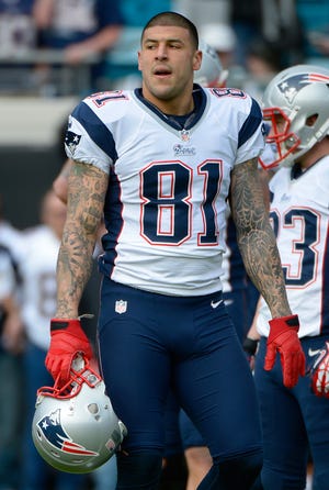 In this Dec. 23, 2012 file photo, New England Patriots tight end Aaron Hernandez (81) warms up prior to an NFL football game against the Jacksonville Jaguars in Jacksonville, Fla.