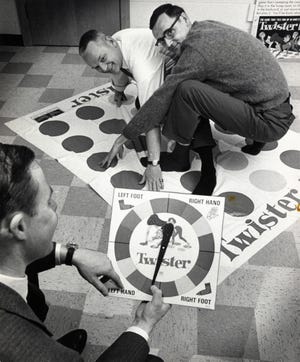 In a Dec. 16,1966 photo, co-inventors of the game "Twister" Charles Foley, left, and Neil Rabens demonstrate the game for Charles McCarty, foreground, president of Research and Development, Inc., in Minnesota. Chuck Foley, co-inventor of the iconic Twister game that launched decades of awkward social interactions at parties, died Monday, July 1, 2013, at a care facility in St. Louis Park, Minn, according to his son, Mark Foley. He was 82. (Pioneer Press: Buzz Magnuson)