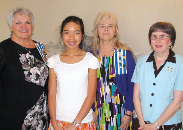 Linda Rivenbark, left, presents Belinda Y Hu, center left, a check as the District IX winner of the DAR American History Essay contest. Jo Ann Huettl, center right, and Lisa Whitfield look on.