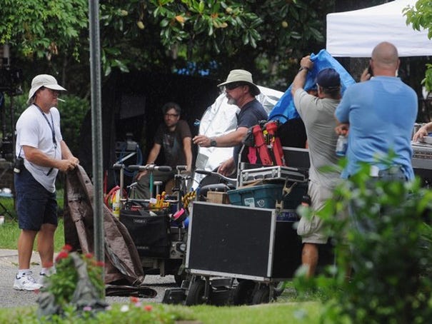A film crew with the locally filmed CBS show 'Under the Dome' films a scene with actor John Elvis and actress Mackenzie Lintz in front of a home on Brookwood Avenue in Wilmington on Thursday