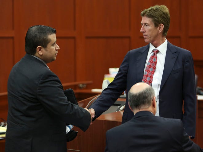George Zimmerman, left, shakes hands with his defense attorney Mark O'Mara during a recess in his trial in Seminole circuit court in Sanford Wednesday.