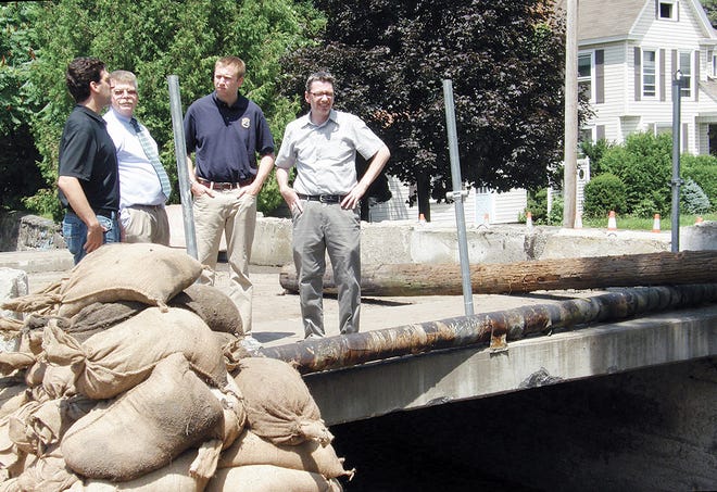 Officials reviewed some of the flood-damaged areas throughout the village of Herkimer on Thursday, including the Church Street bridge. Pictured from left are state Department of Financial Services Superintendent Benjamin Lawsky, Herkimer County Legislator Gary Hartman, DFS representative Daniel Burstein and Herkimer Mayor Mark Ainsworth.