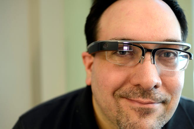 Anton Peck sports the Google Glass he is testing as part of a nationwide trial of the device. Google Glass has a camera, touch pad, battery and microphone built into spectacle frames with a display just above one’s field of vision. Peck works at OneFire Inc., a start-up company based in Peoria.