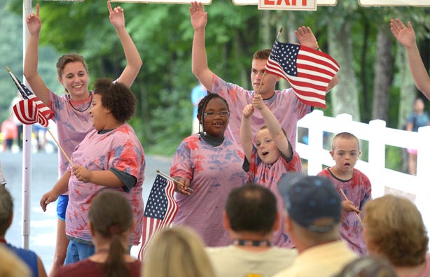 The Camp Green Leaves' "Sweetgums" group performs a dance to "Party in the U.S.A." for families and friends at Lake Cammack on Thursday.